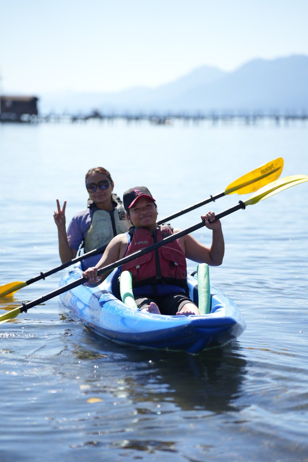 Two Nepali wheelchair basketball coaches kayaking on Lake Tahoe.