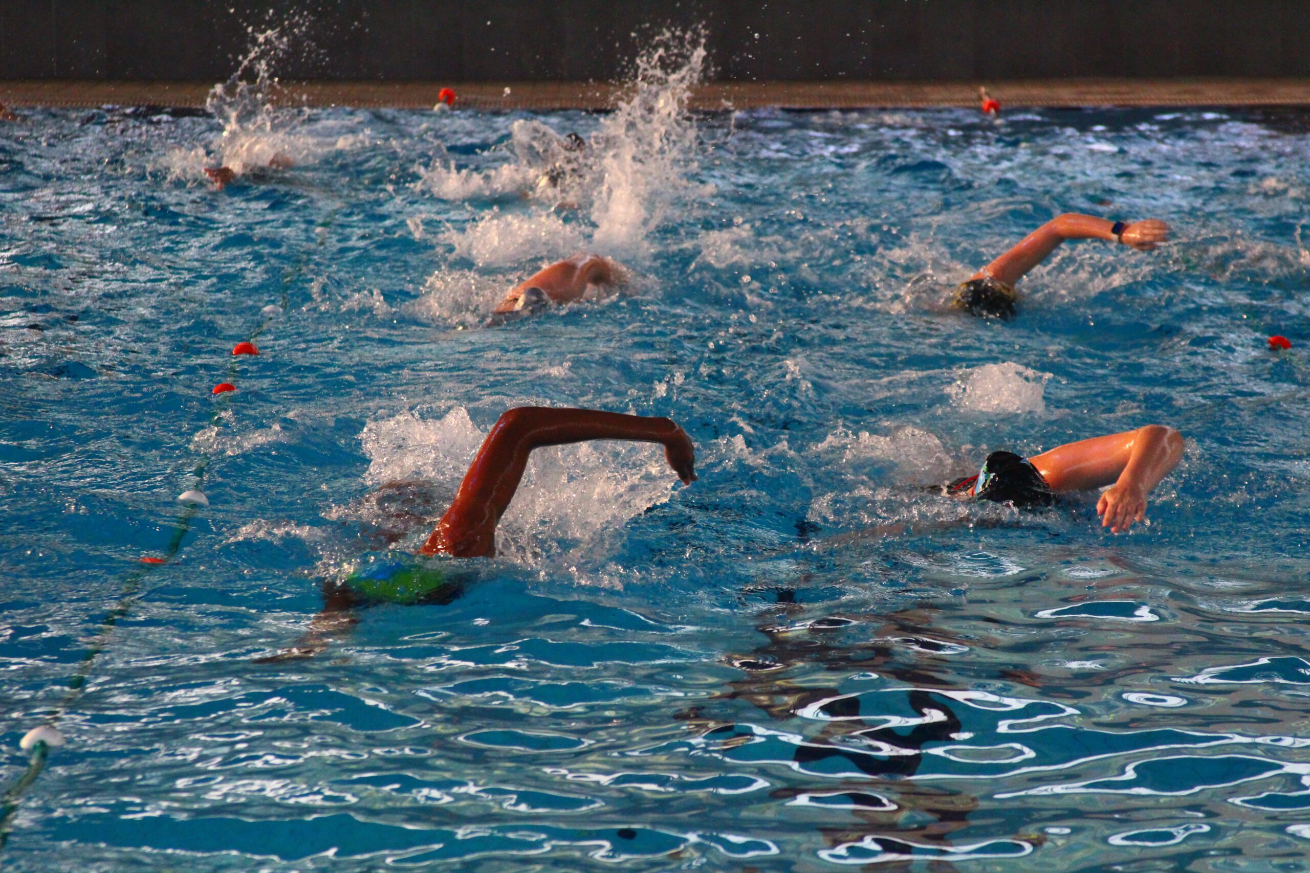 Six girls high school swimmers swimming in practice at a pool in Montenegro