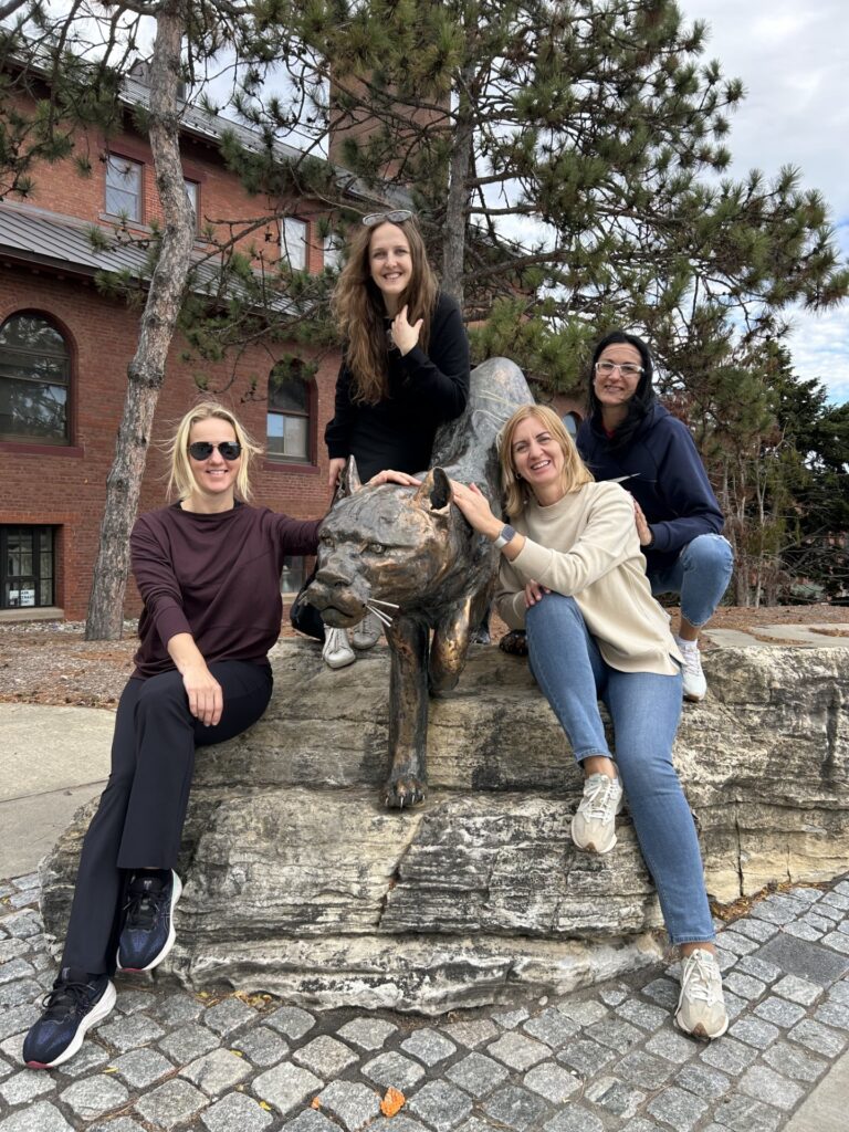 Latvian participants with UVM Catamount statue