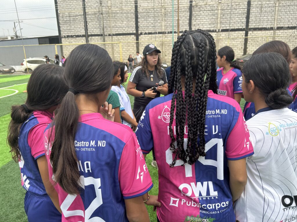 Coach Gissela talking with her girls soccer club