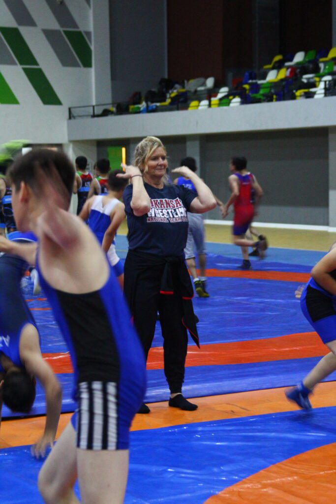 A U.S. participant helping with warmups during a wrestling practice in Azerbaijan. 
