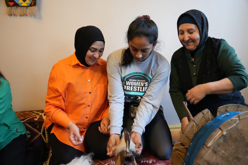 A U.S. participant learning to pull wool at a Women's Hosiery in Azerbaijan